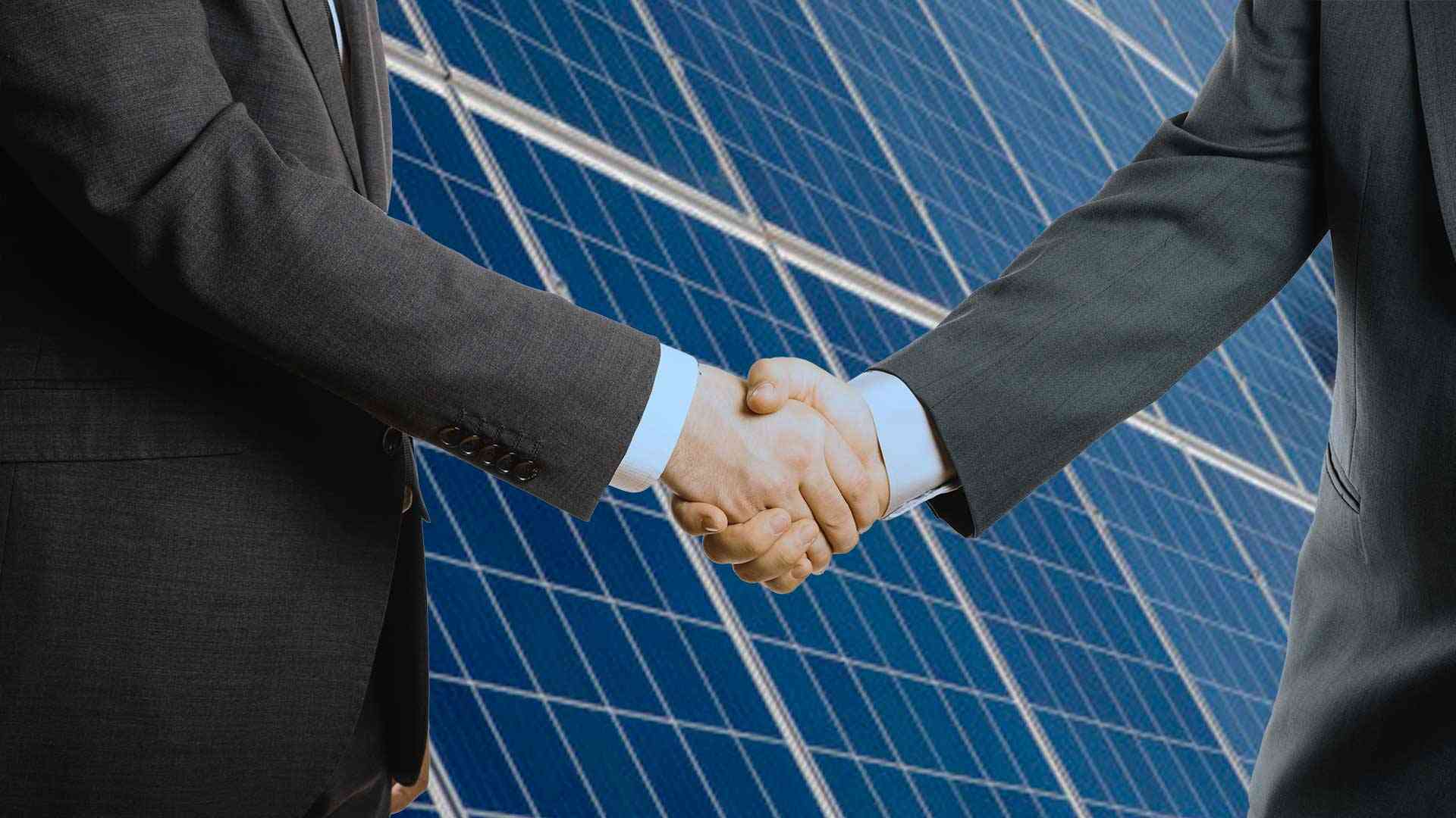 solar panel business partners shaking hands